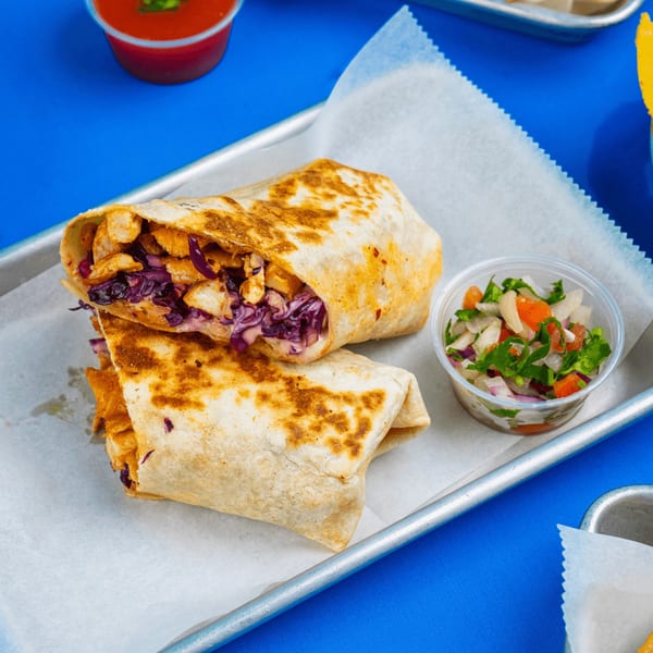 Two Tacos & Bla Bla Bla burritos with chicken and purple cabbage, served with a side of pico de gallo.