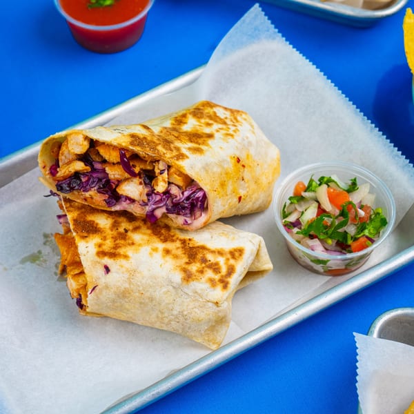 Two Tacos & Bla Bla Bla burritos with chicken and red cabbage, served with pico de gallo.